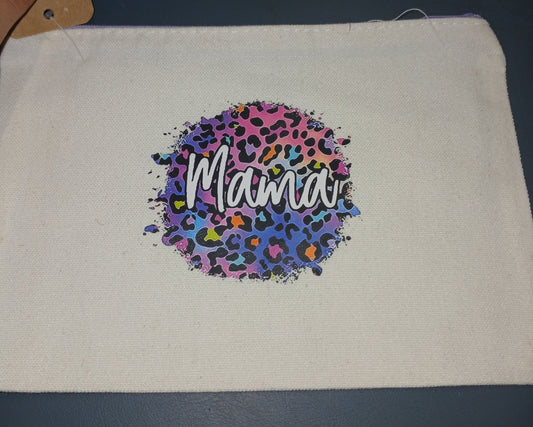 Canvas pouch with colorful 'Mama' design on a dark surface